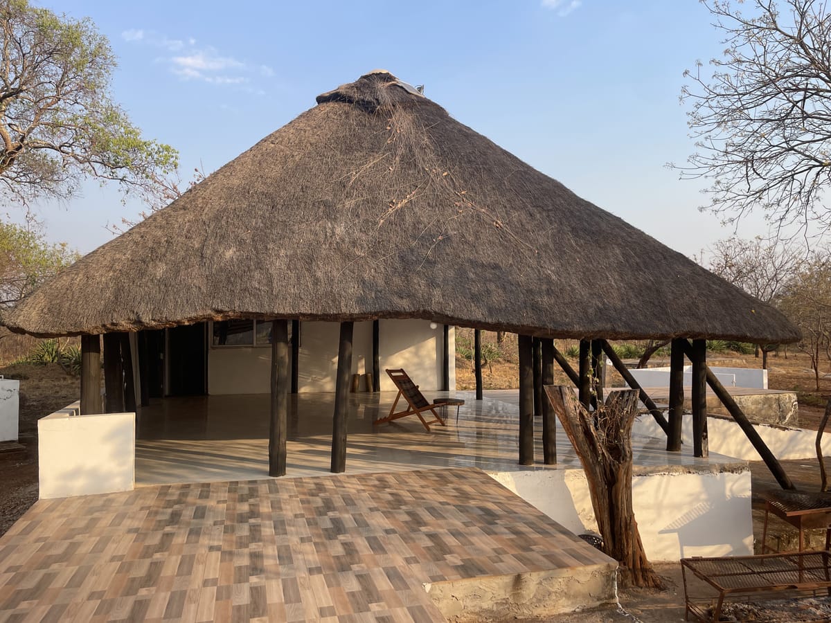 Thatched-roof building and deck at Camp Kobya